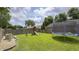 Spacious backyard featuring a swing set, trampoline, and lush green grass perfect for Gathering activities at 408 Ottawa Dr, Indianapolis, IN 46217