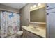 Bathroom featuring unicorn-themed shower curtain, a neutral vanity, and tile flooring, perfect for a whimsical touch at 408 Ottawa Dr, Indianapolis, IN 46217