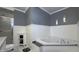 Bright bathroom boasts a corner tub, tile flooring, and gray accents for a soothing, spa-like experience at 408 Ottawa Dr, Indianapolis, IN 46217