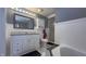 Well-lit bathroom featuring a shower, white cabinets, and elegant finishes, creating a clean and modern space at 408 Ottawa Dr, Indianapolis, IN 46217