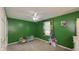 Green bedroom with a ceiling fan and a window with natural light, creating a comfortable and inviting space at 408 Ottawa Dr, Indianapolis, IN 46217