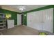 Cozy bedroom with vibrant green walls, plush carpeting, and ample closet space, perfect for a retreat at 408 Ottawa Dr, Indianapolis, IN 46217