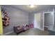 Charming bedroom with soft purple walls, cozy carpet, and playful decor, creating a whimsical and inviting space at 408 Ottawa Dr, Indianapolis, IN 46217