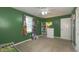 View of a cheerful green bedroom with ample natural light, closet space, and a cozy atmosphere at 408 Ottawa Dr, Indianapolis, IN 46217