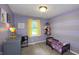 Bright bedroom features a striped accent wall, cozy carpet, and whimsical decor, perfect for a retreat at 408 Ottawa Dr, Indianapolis, IN 46217