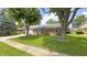 Charming brick ranch home featuring mature trees and a well-maintained lawn at 408 Ottawa Dr, Indianapolis, IN 46217