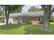 Charming brick ranch home with an attached garage and manicured front yard at 408 Ottawa Dr, Indianapolis, IN 46217
