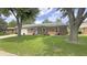 Charming brick house with well-maintained lawn, mature trees, and attached garage at 408 Ottawa Dr, Indianapolis, IN 46217