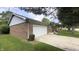 Brick home featuring an attached garage and a well-maintained lawn at 408 Ottawa Dr, Indianapolis, IN 46217
