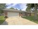 Single-story brick home with attached garage and a well-maintained lawn and mature trees at 408 Ottawa Dr, Indianapolis, IN 46217