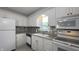 Well-lit kitchen with white appliances, cabinets, and stylish backsplash at 408 Ottawa Dr, Indianapolis, IN 46217