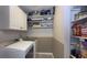 Well-organized laundry room features new washer and dryer with storage shelving at 408 Ottawa Dr, Indianapolis, IN 46217