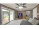 Comfortable living room with ceiling fan, sliding glass door to a deck, and gray sectional sofa at 408 Ottawa Dr, Indianapolis, IN 46217