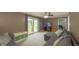 Living room featuring a gray sectional sofa, TV, sliding glass door to the backyard and deck at 408 Ottawa Dr, Indianapolis, IN 46217