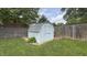 Backyard storage shed with a light blue exterior and a well-maintained lawn at 408 Ottawa Dr, Indianapolis, IN 46217
