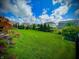 Large backyard with a manicured lawn, decorative trees, and plenty of space for outdoor activities at 4281 Viewforth Ln, Bargersville, IN 46106