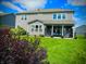 Green backyard showcasing a well-manicured lawn, and covered patio with comfortable outdoor furniture at 4281 Viewforth Ln, Bargersville, IN 46106