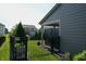 Fenced backyard with garden beds, landscaping, and partial view of adjacent homes at 4281 Viewforth Ln, Bargersville, IN 46106