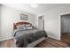 Comfortable bedroom with wood floors, queen size bed, and decorative artwork at 4281 Viewforth Ln, Bargersville, IN 46106