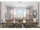 Elegant dining room with a large table, decorative chairs, and natural light from a large window at 4281 Viewforth Ln, Bargersville, IN 46106