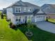 Charming two-story home boasts beautiful landscaping, a lush lawn, and a convenient two-car garage at 4281 Viewforth Ln, Bargersville, IN 46106