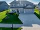 Inviting two-story home featuring a well-manicured lawn, spacious driveway, and a charming two-car garage at 4281 Viewforth Ln, Bargersville, IN 46106