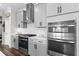Well-equipped kitchen with stainless steel appliances, modern gas range, and stylish gray cabinetry at 4281 Viewforth Ln, Bargersville, IN 46106