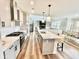An open concept kitchen featuring a large island with pendant lighting and modern stainless steel appliances at 4281 Viewforth Ln, Bargersville, IN 46106