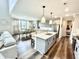 Bright, open kitchen featuring an island with seating, stainless appliances, and a dining area with large windows at 4281 Viewforth Ln, Bargersville, IN 46106