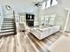A spacious living room featuring a fireplace, large windows, vaulted ceilings, and hardwood floors at 4281 Viewforth Ln, Bargersville, IN 46106