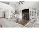 Inviting living room with a fireplace, staircase and a large comfortable sectional sofa and wood floors at 4281 Viewforth Ln, Bargersville, IN 46106
