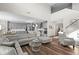 Open-concept living room flows into kitchen, featuring high ceilings, a large sofa and wood floors at 4281 Viewforth Ln, Bargersville, IN 46106