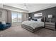 Beautiful main bedroom with a gray accent wall, plush carpet, and a comfortable seating area at 4281 Viewforth Ln, Bargersville, IN 46106
