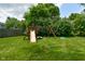 Backyard with a lawn, various trees and mature landscaping, and a play set at 4585 Abbey Dr, Carmel, IN 46033