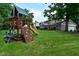 Expansive backyard features a wooden playset and a lush green lawn, perfect for outdoor activities and Gathering fun at 4585 Abbey Dr, Carmel, IN 46033