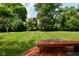 Well-maintained backyard featuring a lush lawn and trees at 4585 Abbey Dr, Carmel, IN 46033