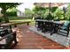 Backyard deck with outdoor dining area, seating, and a view of the grassy backyard at 4585 Abbey Dr, Carmel, IN 46033