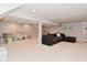 Spacious basement with modern furniture, neutral carpet, and ample lighting for entertaining or relaxing at 4585 Abbey Dr, Carmel, IN 46033