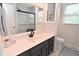 Stylish bathroom featuring a white countertop, gray cabinetry, and a large mirror with black hardware at 4585 Abbey Dr, Carmel, IN 46033