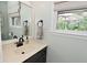 Bright bathroom featuring a stylish vanity, updated fixtures, and a window with a view at 4585 Abbey Dr, Carmel, IN 46033