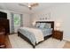 The bedroom features a patterned comforter, ceiling fan, and hardwood floors at 4585 Abbey Dr, Carmel, IN 46033