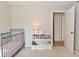 Cozy bedroom featuring a dark metal crib, books and an open door at 4585 Abbey Dr, Carmel, IN 46033