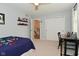 This bedroom has a ceiling fan, carpeting, a desk, and closet doors at 4585 Abbey Dr, Carmel, IN 46033