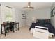 This bedroom features a ceiling fan, white trim and curtains, and a desk and a bed at 4585 Abbey Dr, Carmel, IN 46033