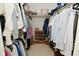 This walk-in closet has racks of clothes, a shoe rack, and a basket on the top shelf at 4585 Abbey Dr, Carmel, IN 46033