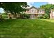 Traditional two-story home featuring a well-manicured lawn and lush landscaping in a suburban neighborhood at 4585 Abbey Dr, Carmel, IN 46033
