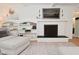 Cozy living room featuring a painted brick fireplace and built-in shelving at 4585 Abbey Dr, Carmel, IN 46033