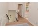 Well-lit hallway with wood flooring, stairs and neutral walls connecting various rooms in the house at 4585 Abbey Dr, Carmel, IN 46033