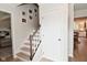 Bright hallway with stairs and hardwood floors offering glimpses of other rooms and ample natural light at 4585 Abbey Dr, Carmel, IN 46033