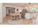 Eat-in kitchen boasts granite countertops, white cabinets, stainless steel appliances, and a sunny breakfast area at 4585 Abbey Dr, Carmel, IN 46033